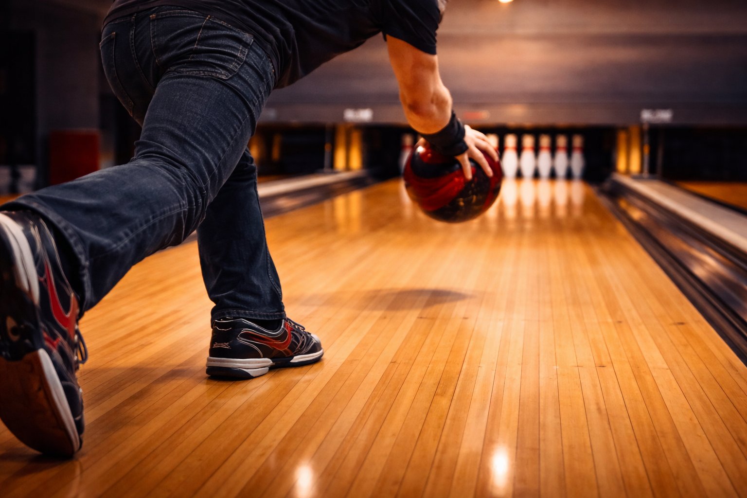 Colorful reactive resin bowling balls in a ball return rack at a bowling center